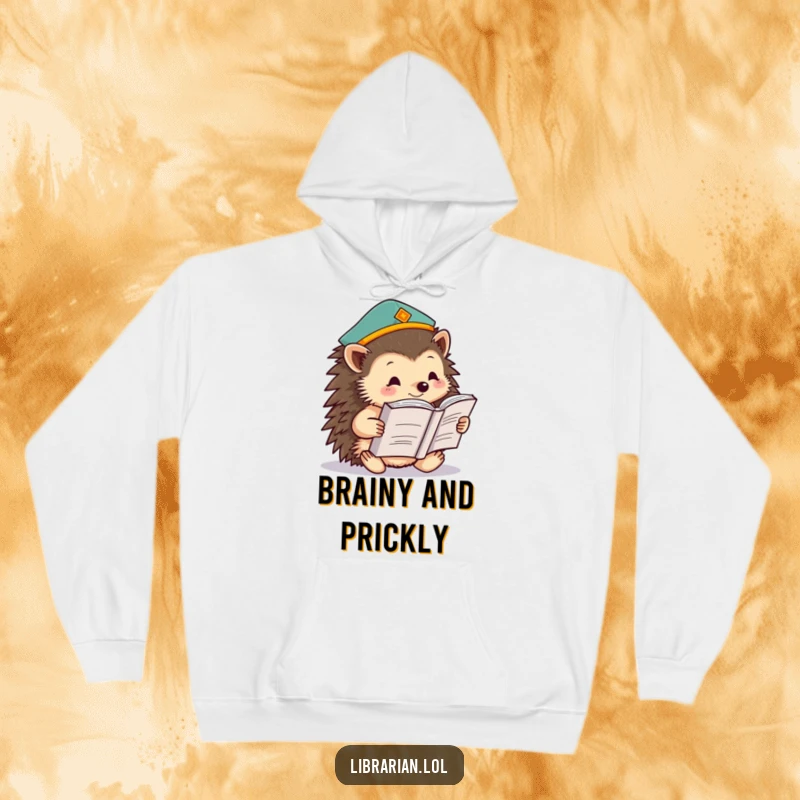 Funny hedgehog wearing a graduation cap, reading a giant book on a soft hoodie, symbolizing cozy learning and humorous intelligence.