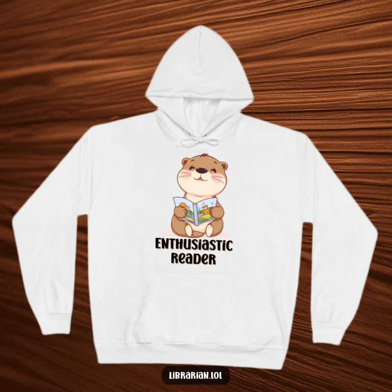 Funny hoodie with a sweet otter enthusiastically showing a picture book, perfect for cozy reading adventures.