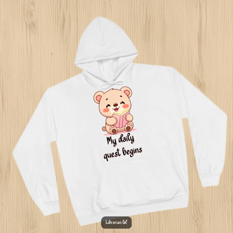 Funny hoodie with a happy bear cub holding a glowing bookmark, designed for cozy reading sessions.