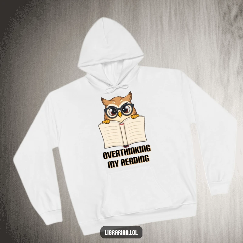 Funny owl wearing glasses peeking over a giant book, featured on a warm, comfortable hoodie for book lovers.