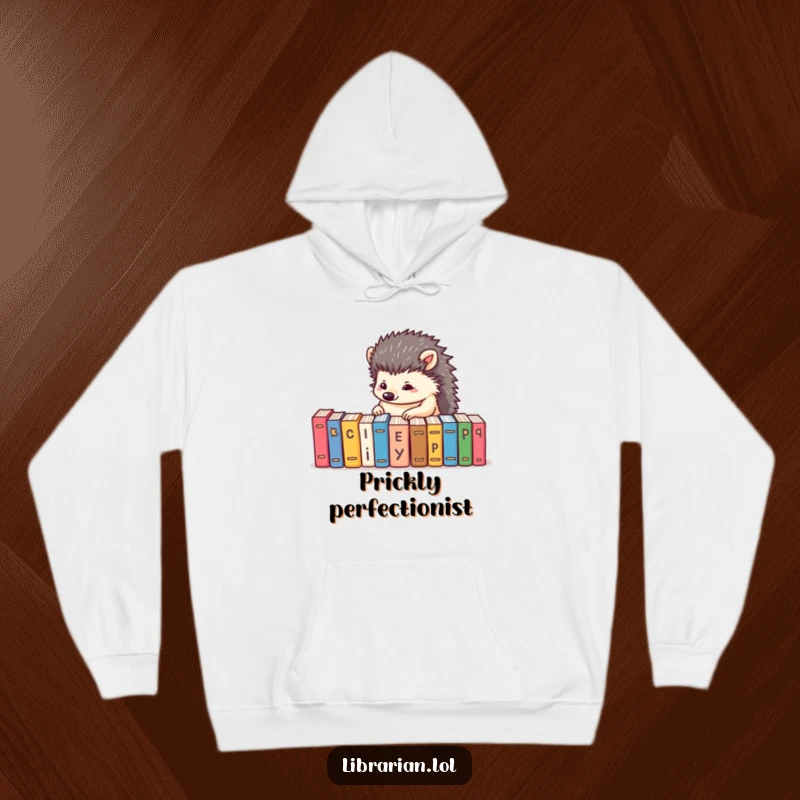Funny hoodie showcasing a determined hedgehog alphabetizing tiny books, offering warmth and a love for order.