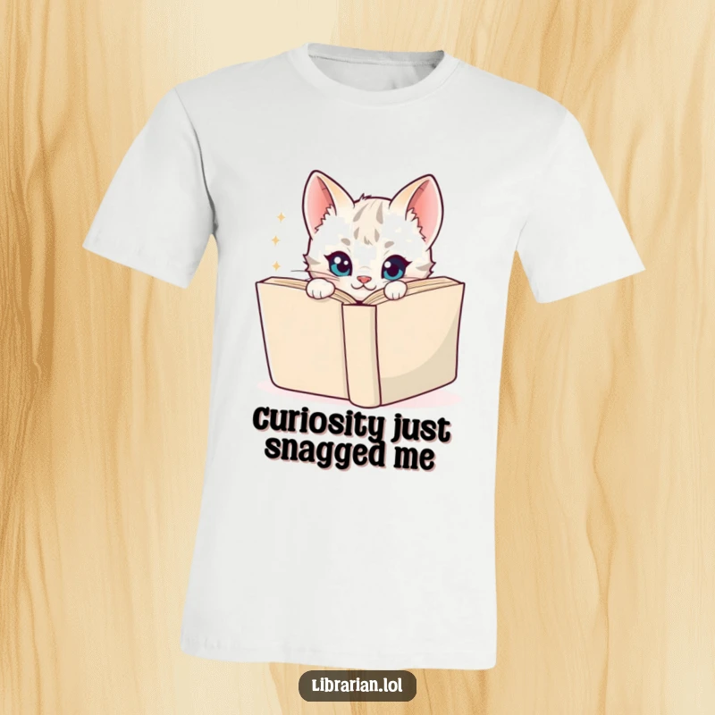 Funny T-Shirt with a playful cartoon kitten peeking from behind a book, sporting a mischievous, sparkly look, great for readers.
