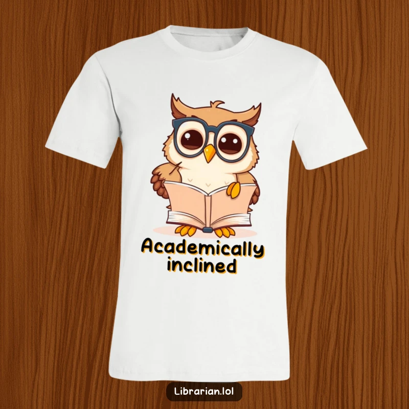 Funny owl scholar t-shirt with a cute cartoon owl in spectacles pointing at an open book, exuding discovery.